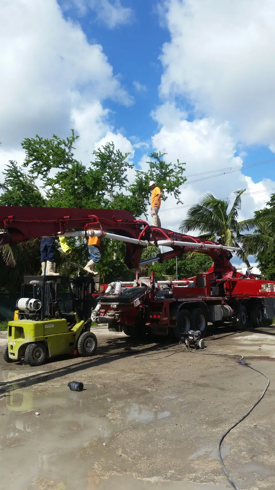 Crew setting up a red boom pump