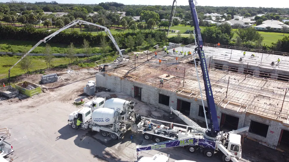Boom pump placing concrete on an elevated deck, aerial view