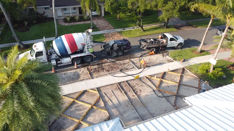 Mixer truck and line pump on a home addition, aerial view