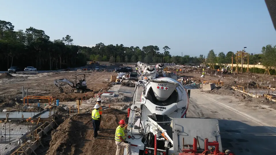 Mixer truck feeding a pump on a large construction site